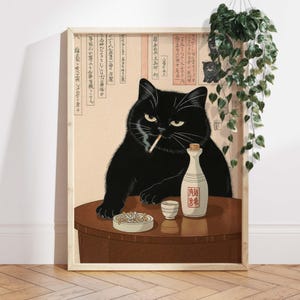 May include: Framed art print featuring a black cat with a cigarette, sitting at a table with a bottle of sake and an ashtray. The artwork has a vintage aesthetic with Japanese text and a small cat illustration.