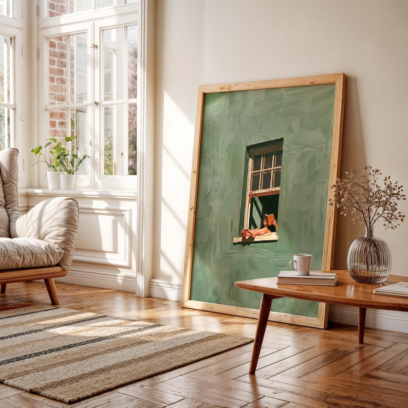 May include: A large framed artwork featuring a green wall with a window scene. The artwork is propped against a wall in a sunlit room with a wooden coffee table, a vase, and a rug. The window scene depicts a person relaxing.