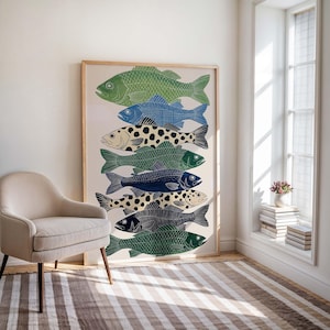 May include: A framed art print featuring a stack of stylized fish in various shades of green, blue, and black. The fish have detailed patterns and textures, creating a visually appealing design. The artwork is displayed in a light-colored wooden frame.