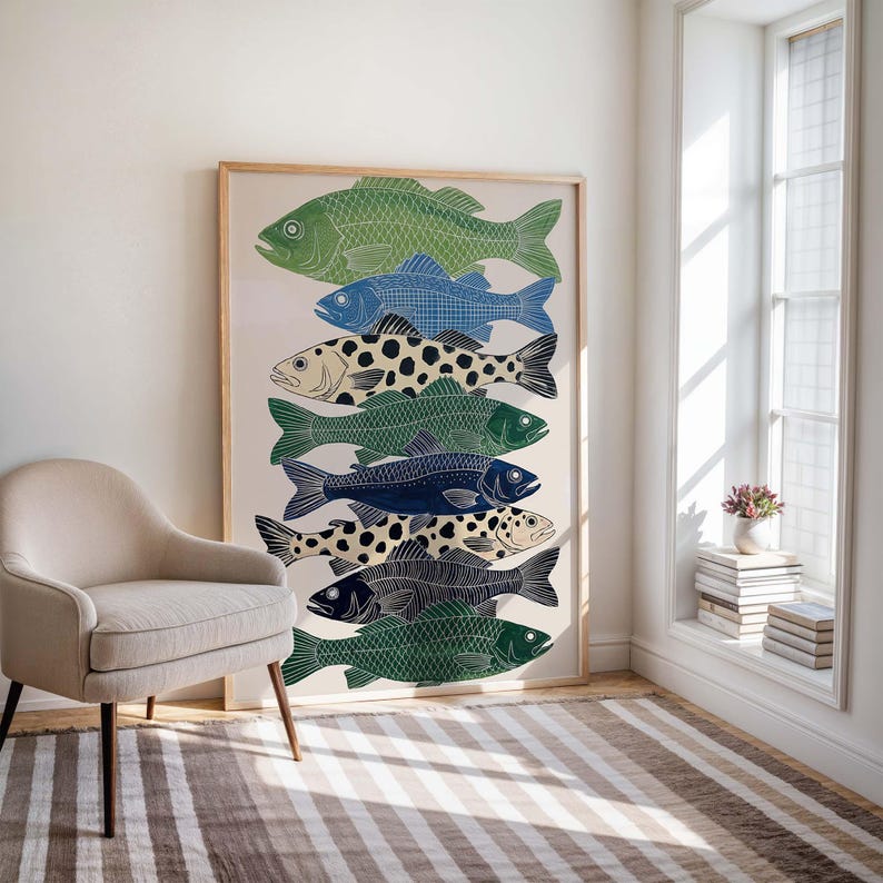 May include: A framed art print featuring a stack of stylized fish in various shades of green, blue, and black. The fish have detailed patterns and textures, creating a visually appealing design. The artwork is displayed in a light-colored wooden frame.