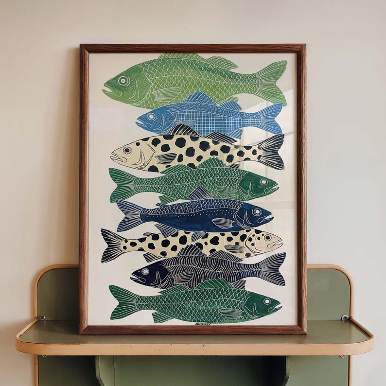 May include: A framed art print featuring a collection of stylized fish illustrations. The fish are depicted in various colors, including green, blue, and black, with patterned details. The artwork is displayed in a brown wooden frame, suitable for home decor.