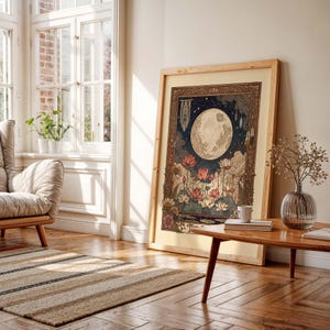 May include: A framed art print depicting a full moon, lotus flowers, and a starry night sky. The artwork has a vintage aesthetic with a light wood frame. The colour palette includes blues, pinks, and earth tones, creating a serene and decorative piece.