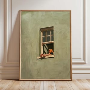 Puede incluir: Una impresión artística de una escena de ventana. La obra de arte representa a una persona leyendo un libro, con los pies apoyados en el alféizar de la ventana. El libro es naranja y la pared está pintada en tonos verdes. La obra está enmarcada en un marco de madera.