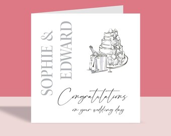May include: A white wedding card with a black and white illustration of a wedding cake, champagne bottle, and glasses. The text "Sophie & Edward" is printed in gray on the left side of the card. The text "Congratulations on your wedding day" is printed in black cursive at the bottom of the card.