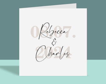 May include: A white card with the text "08.Rebecca.07. & Charles 2024" in black and beige.