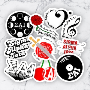 May include: A collection of stickers with various designs, including a black and white moon phase circle, a red rose with a sword, and musical notes. The stickers feature the Greek letters ΣΑΙ and the words "Sigma Alpha Iota."
