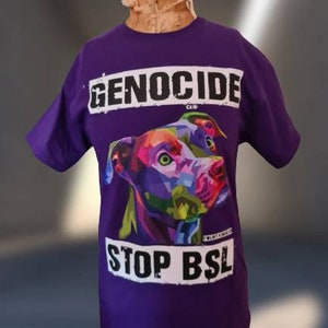 May include: Purple t-shirt featuring a colourful graphic of a pit bull dog and the text "GENOCIDE CAN'T" and "STOP BSL".