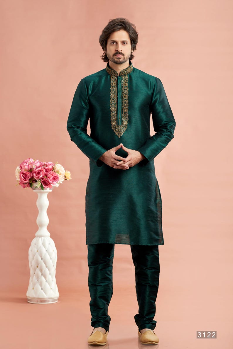 May include: A dark teal kurta pajama set. The long-sleeved top features gold embroidery around the collar and down the front. The matching pants complete the ensemble. The number "3122" is in the bottom right corner.