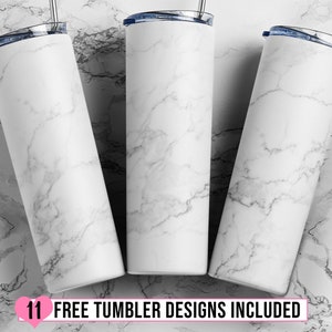 May include: Three white marble-patterned stainless steel tumblers with blue lids and straws.  The tumblers are arranged in a triangle shape on a white marble surface.  The text "11 FREE TUMBLER DESIGNS INCLUDED" is at the bottom of the image.