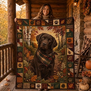 May include: A rectangular quilt featuring a central image of a brown Labrador dog wearing a plaid bandana, surrounded by an autumn forest scene with birch trees and fallen leaves. The border consists of squares with paw prints and foliage.