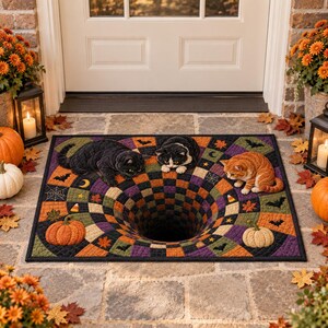 May include: A rectangular doormat featuring a 3D optical illusion of a deep black hole surrounded by a checkered pattern in orange, purple, and green. The mat is decorated with three cats, pumpkins, bats, spiderwebs, and autumn leaves.