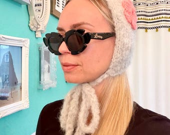 Fluffy knitted bonnet with flowers for women – soft winter hat, hand-knitted fashion accessory, tie-on balaclava