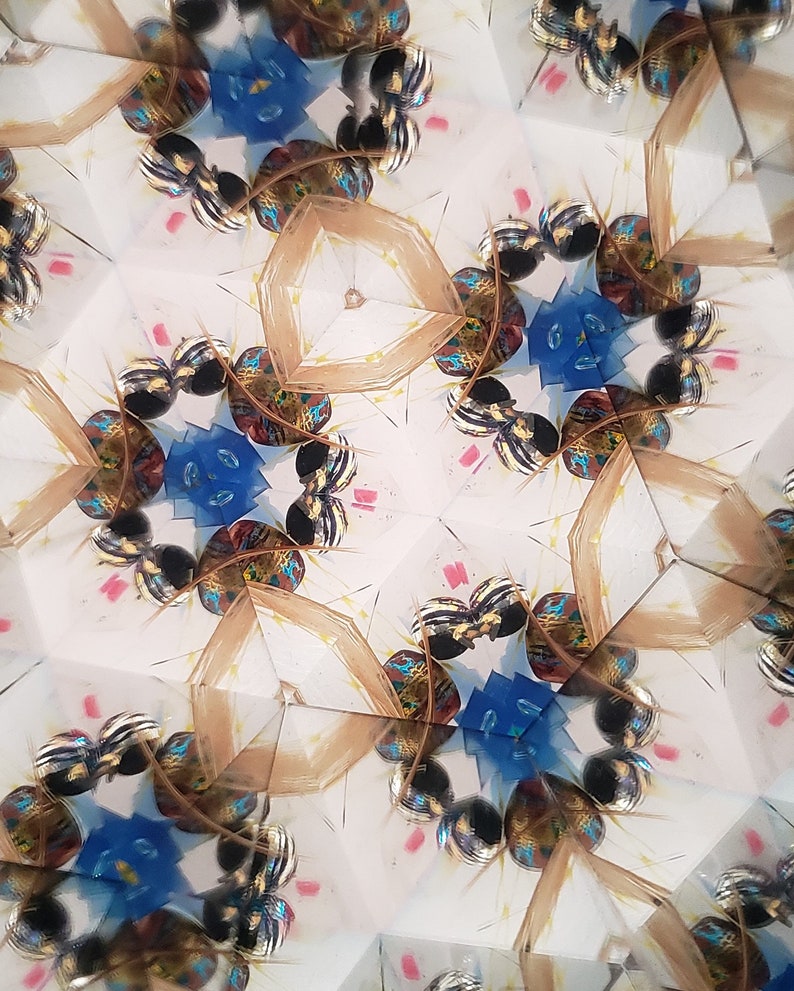 May include: A kaleidoscope image with a repeating pattern of blue, gold, and black shapes. The shapes are arranged in a symmetrical pattern, creating a sense of depth and movement.