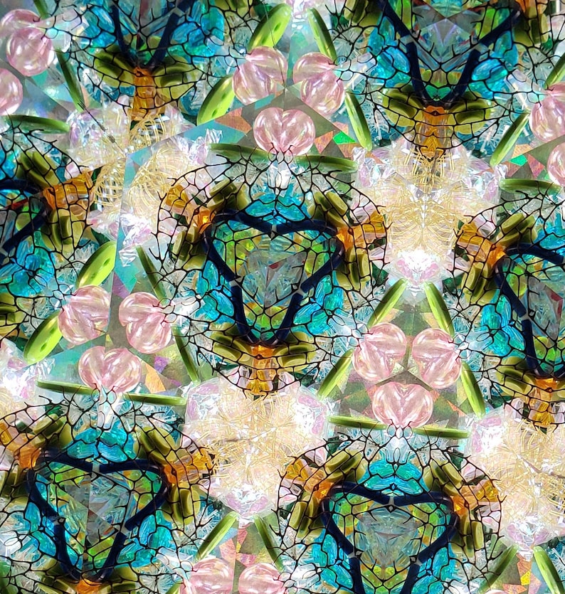 May include: A kaleidoscope image with a repeating pattern of blue, green, and orange geometric shapes. The shapes are arranged in a symmetrical pattern, creating a sense of depth and movement.