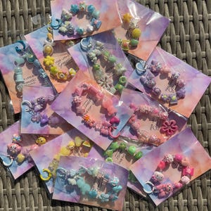 Monochromatic beaded keychains with mixed charms