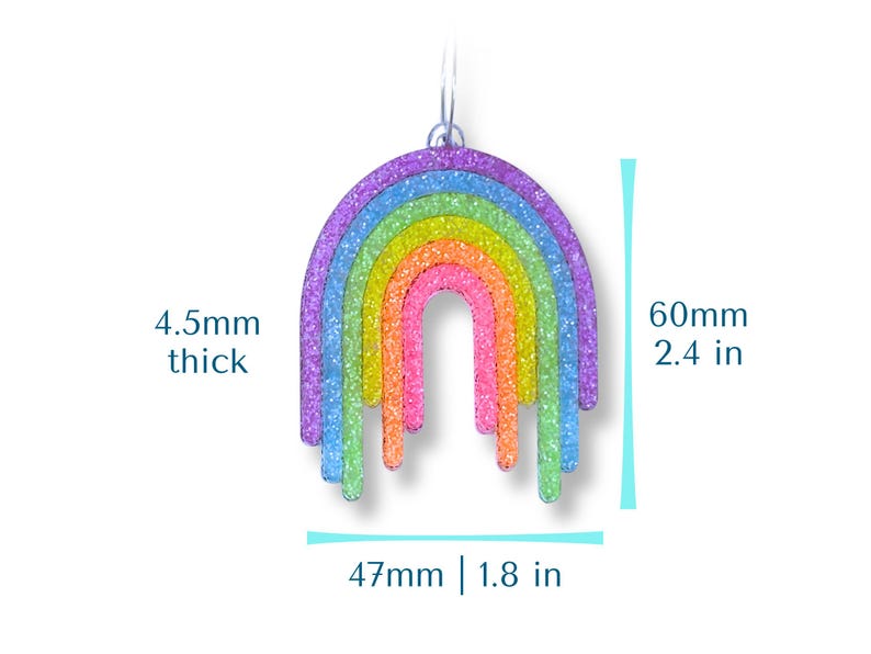 May include: A colorful rainbow-shaped earring with a glittery finish. The earring is 2.4 inches long, 1.8 inches wide, and 4.5mm thick. The rainbow features layers of purple, blue, green, yellow, orange, and pink.
