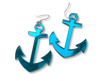 May include: A pair of turquoise anchor-shaped earrings. The earrings have a reflective, metallic finish and are suspended from silver-colored ear wires. The anchor design is a nautical theme, suitable for those who love the sea.