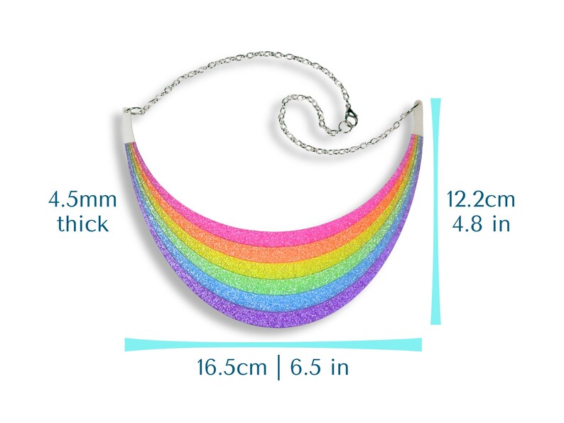 May include: A rainbow-colored glitter necklace with a silver chain. The necklace is 6.5 inches wide, 4.8 inches tall, and 4.5mm thick. The rainbow design features bands of pink, orange, yellow, green, blue, and purple.