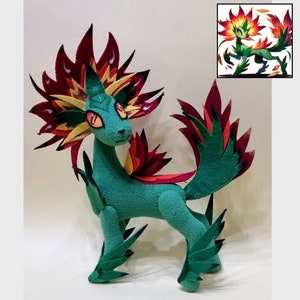 May include: A green plush toy with red and yellow flames for a mane and tail. The toy is standing on a white surface. The toy is a representation of a mythical creature.