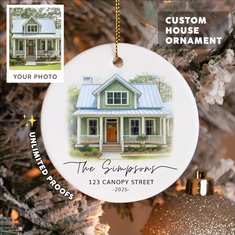 May include: A round white ceramic ornament featuring a watercolor illustration of a green house with a blue roof and a wooden door. The text reads The Simpsons, 123 CANOPY STREET, and -2025-. It hangs from a gold string against a blurred tree background.