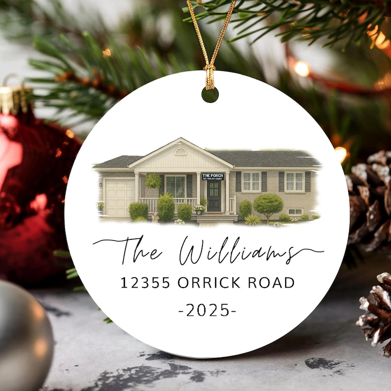 May include: A round white ceramic ornament featuring a watercolor illustration of a house with a garage, a porch, and a sign reading THE PORCH. Below the house, the text reads The Williams, 12355 ORRICK ROAD, and -2025- in black font.