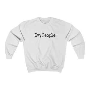 May include: White sweatshirt with the text "Ew, People" in black, centered on the chest. The long-sleeved crewneck top is made of a soft material. A casual, comfortable garment.