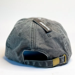 May include: A black denim baseball cap with a black tag that says "Brooklyn Denim Co."