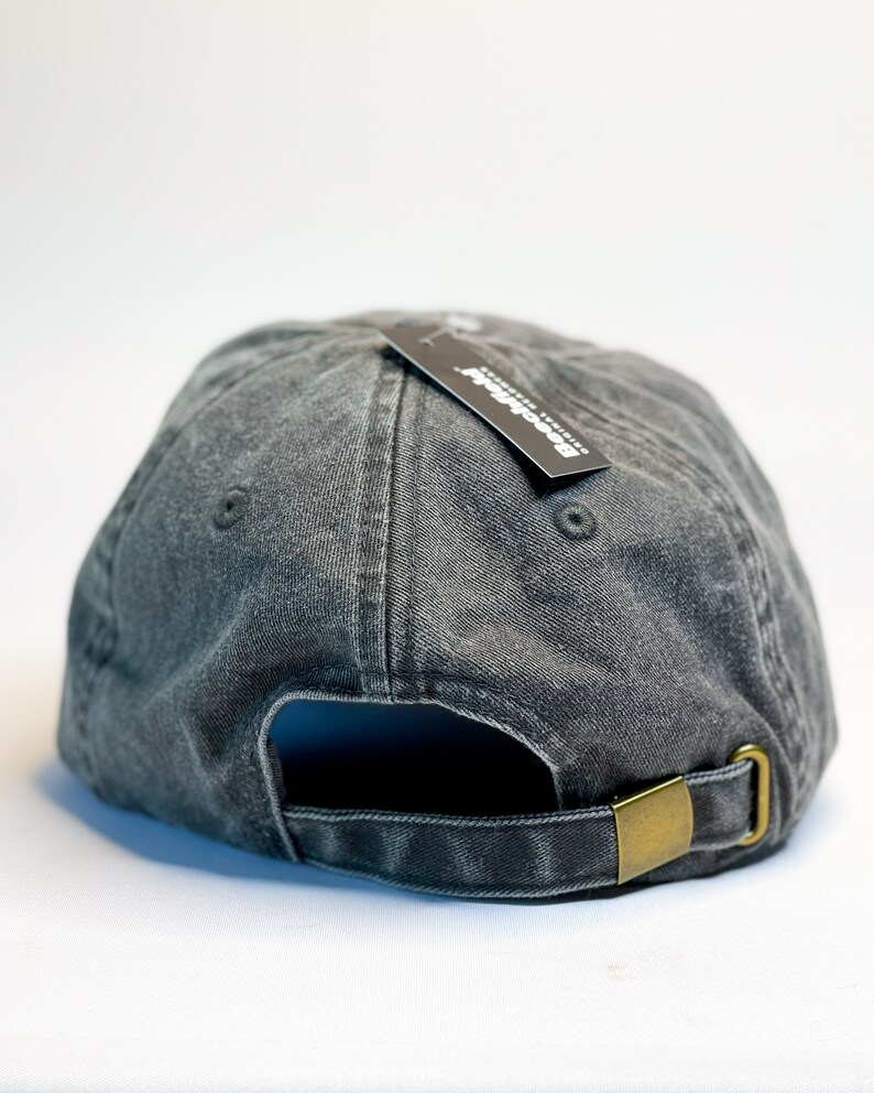 May include: A black denim baseball cap with a black tag that says "Brooklyn Denim Co."