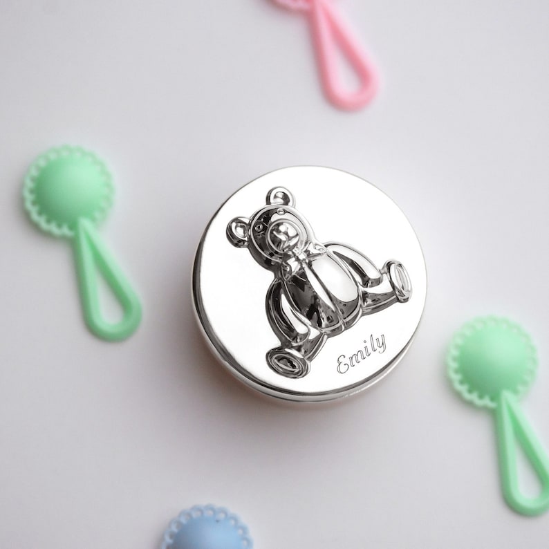 May include: Silver keepsake box with a 3D embossed teddy bear design and the name "Emily" engraved on the front.