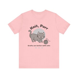 May include: Pink t-shirt with a gray cat illustration and the text "Knit, Purr. Crafts are better with cats."