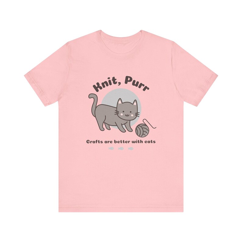 May include: Pink t-shirt with a gray cat illustration and the text "Knit, Purr. Crafts are better with cats."