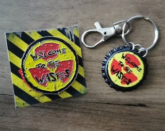 Welcome To The Wastes Logo Pin + Keychain!