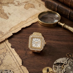 May include: A white ceramic mug with a black handle and the text "But First, Coffee" in a black, handwritten-style font. The mug is on a white surface.