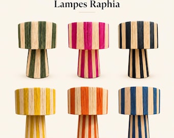 May include: Six mushroom-shaped table lamps labeled Lampes Raphia, each wrapped in natural raffia with vertical stripes in green, pink, black, yellow, orange, and blue. The lamps feature a cylindrical base and a wide, flat-topped shade design.
