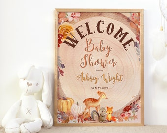 May include: Welcome sign for a baby shower with a woodgrain background and fall-themed decorations. The sign says "Welcome Baby Shower honoring Aubrey Wright 04 MAY 2022".