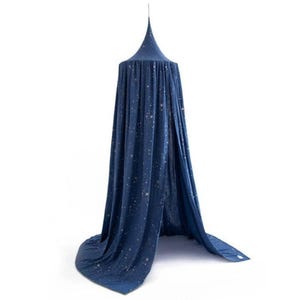 May include: A navy blue bed canopy with a starry night design. The canopy has a conical top and drapes down to the floor. The fabric is decorated with small, gold-colored stars, creating a celestial theme.