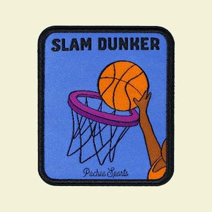 May include: A rectangular patch with a blue background and a black border. The patch features a basketball going into a hoop, with the words "SLAM DUNKER" at the top. The text "Pachee Sports" is at the bottom.