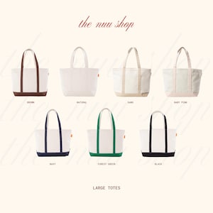 May include: Collection of large tote bags in various colors, including brown, natural, sand, baby pink, navy, forest green, and black. Each bag features a white canvas body with colored accents and handles. The text "the nuu shop" is at the top.