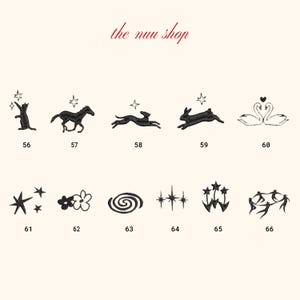 May include: A collection of black embroidered designs, including a cat, horse, deer, rabbit, swans, stars, flowers, a spiral, and other starburst patterns. The text "the nuu shop" is in red script.