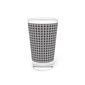 May include: A clear pint glass with a houndstooth pattern in black, white, and gray. The pattern covers the majority of the glass, creating a stylish and modern look. The glass is empty and sits on a white background.