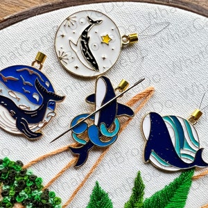 May include: Four whale-themed embroidery kits with blue and white whale designs and gold threaders. Each kit features a different whale design.