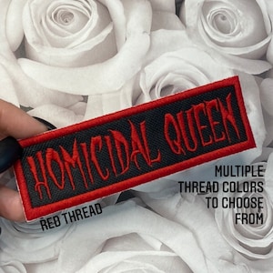 May include: A rectangular black patch with red embroidered text that reads "HOMICIDAL QUEEN". The patch has a red border and the text is in a gothic font. The image also includes the text "MULTIPLE THREAD COLORS TO CHOOSE FROM" and "RED THREAD".
