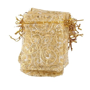 May include: A stack of gold organza gift bags with a white swirl pattern and gold drawstring closures.