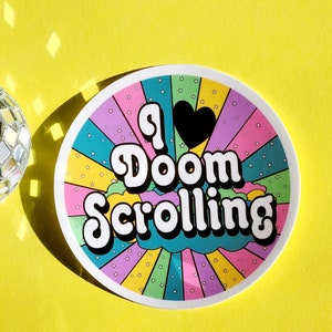 May include: A colorful sticker with a rainbow background and white stars. The sticker says "I ♥ Doom Scrolling" in a retro font.