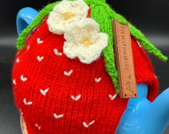 Knitted strawberry tea cosy