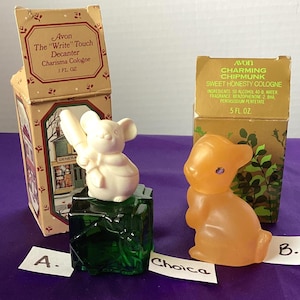 May include: Two vintage Avon cologne bottles. One is a cream-colored mouse figure on a green glass base, and the other is an orange chipmunk figure. Both are displayed with their original boxes, featuring text and illustrations.