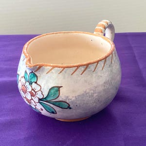 May include: A set of three ceramic nesting bowls in shades of blue, green, and white. The bowls feature a speckled glaze and a simple, modern design. The largest bowl measures approximately 6 inches in diameter.