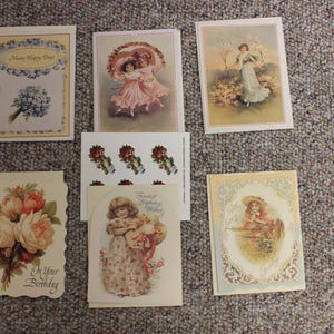 May include: A collection of six vintage-style greeting cards featuring floral illustrations, children in period clothing, and decorative borders. One card displays the text Many Happy Days, another On Your Birthday, and another Fondest Birthday Wishes.