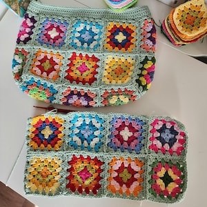 Crochet zipper pouch bag with bright granny-square blocks and mint edging; colorful crochet purse pattern sample.