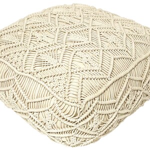 May include: A cream-colored, square-shaped throw pillow with a woven, macrame design.